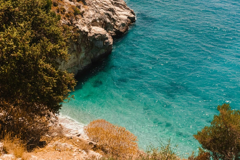 a boat is seen sailing in the clear blue water