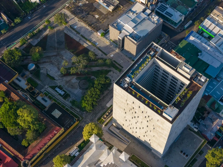 a tall building sits in the middle of some small buildings