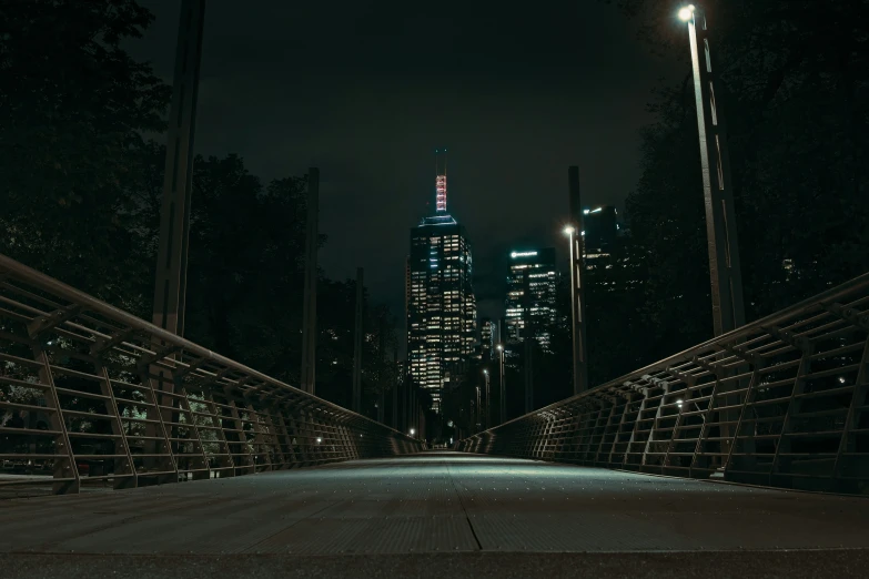 an empty road near buildings in the dark