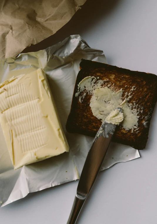 a cake knife is next to a piece of er