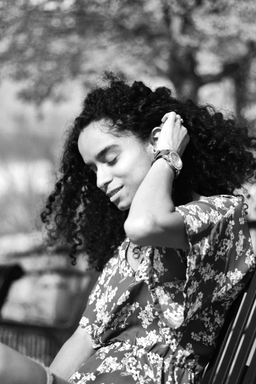 a woman sitting on a bench checking her cell phone