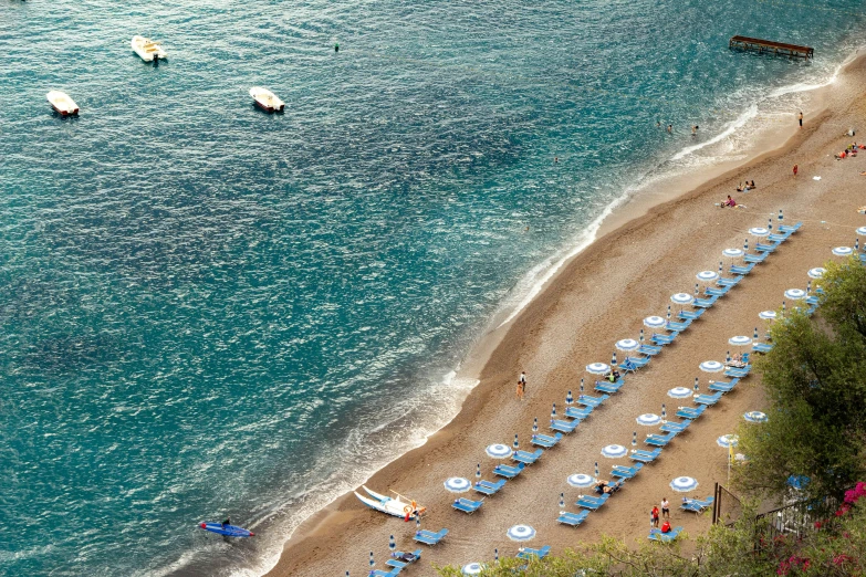 a number of umbrellas on a beach near a body of water