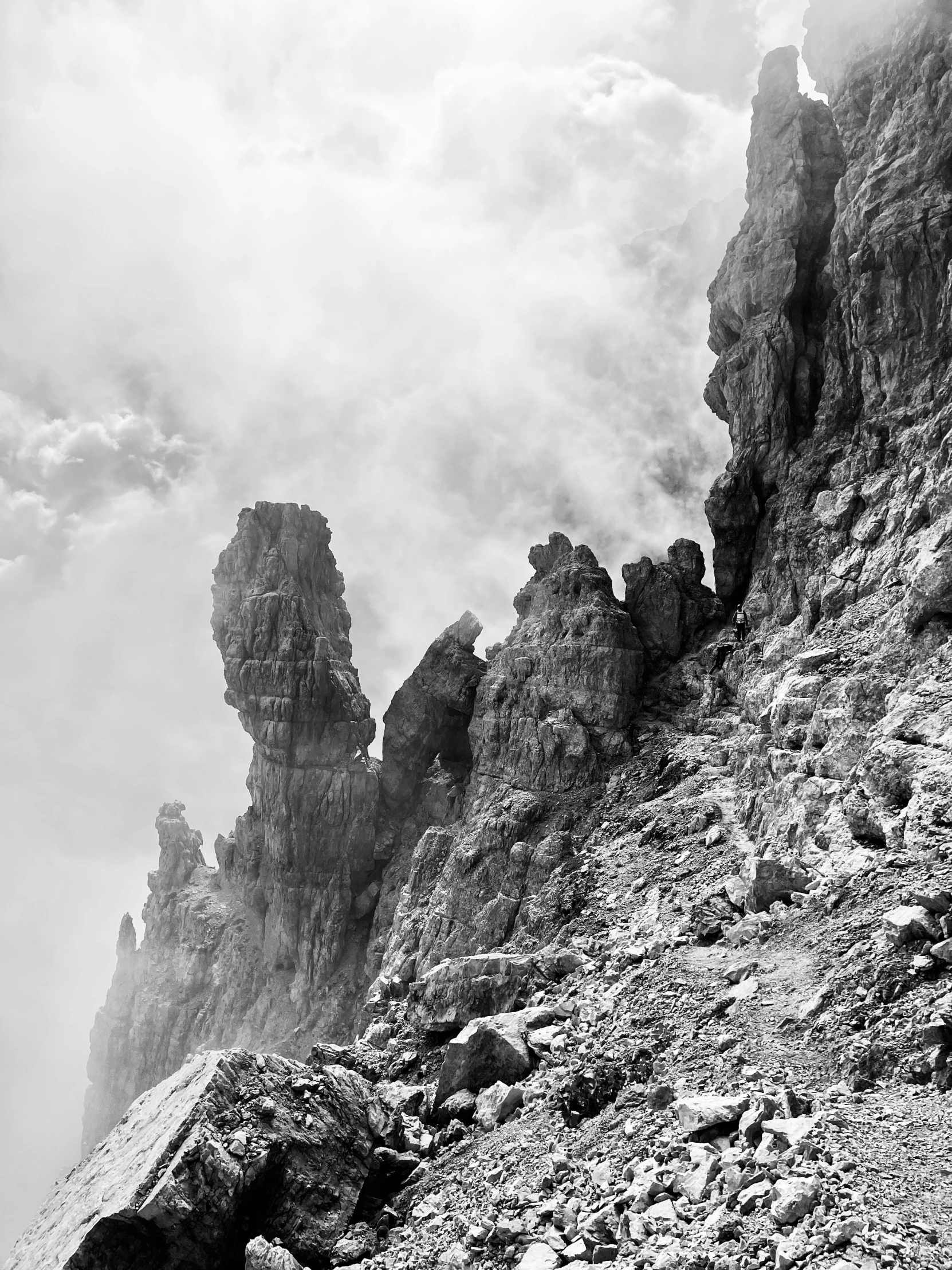 a couple of rocks sitting on the side of a mountain