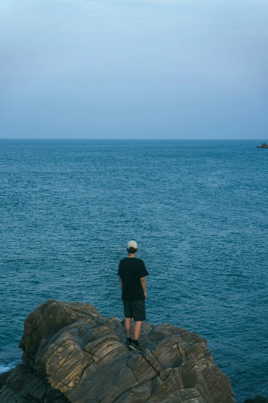 man looking out over the water at soing in the distance