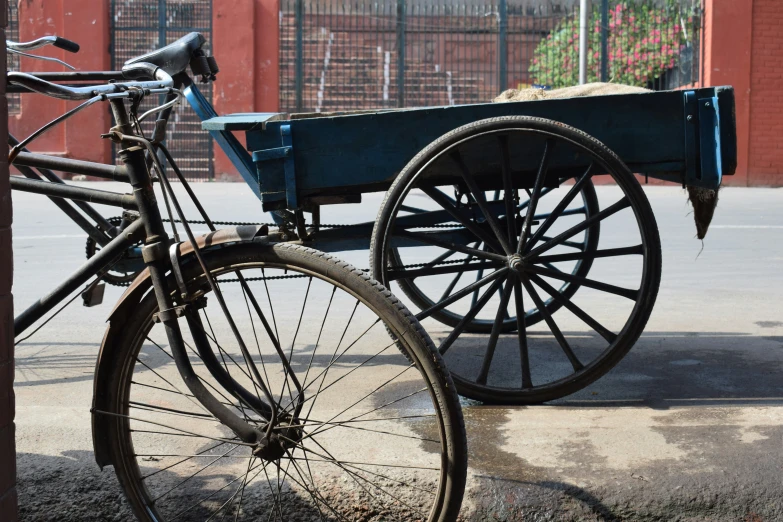 an old wagon behind a bicycle and on the ground