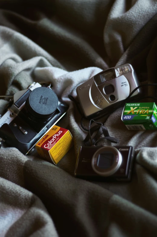 an old camera and some other items on a blanket