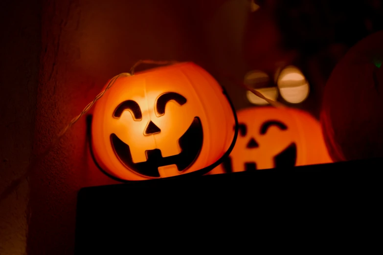 pumpkin heads illuminated with some white light in a dark room