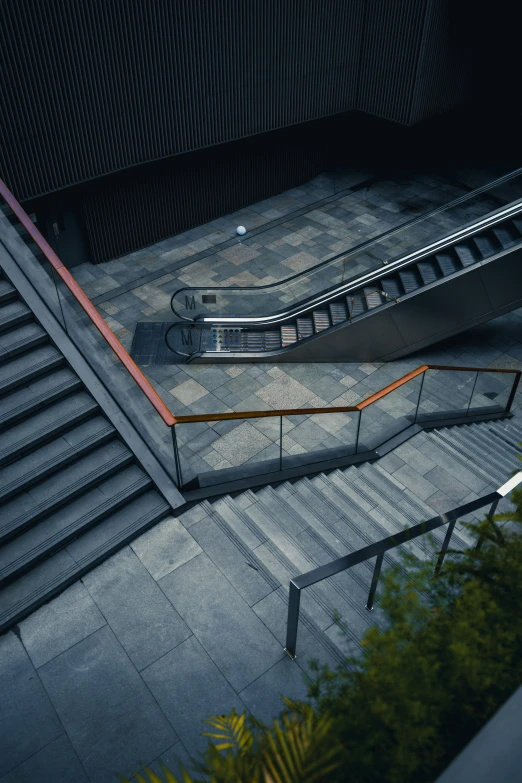 an escalator next to steps with railings