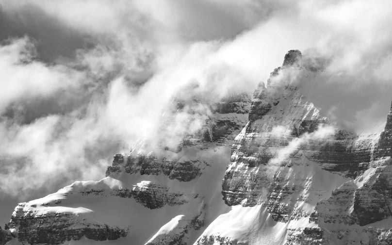 a very tall mountain covered in a dusting of snow