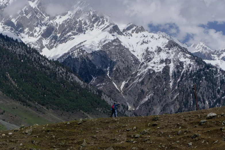 a man is hiking along a mountain slope