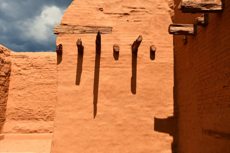 a wall with three brick pillars next to it