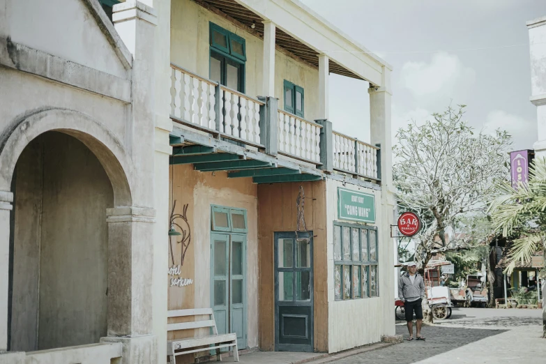 a woman walking on the street in front of a large building