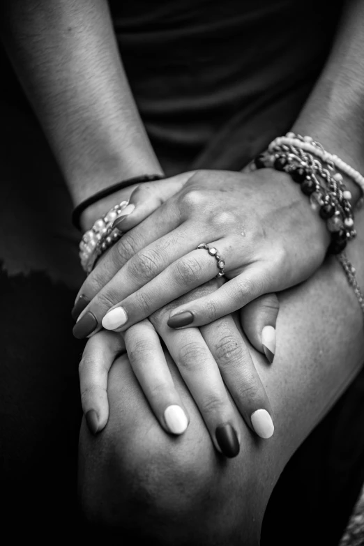 two people with hands together in a black and white po