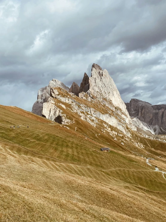 some mountain side with grass and dirt on it