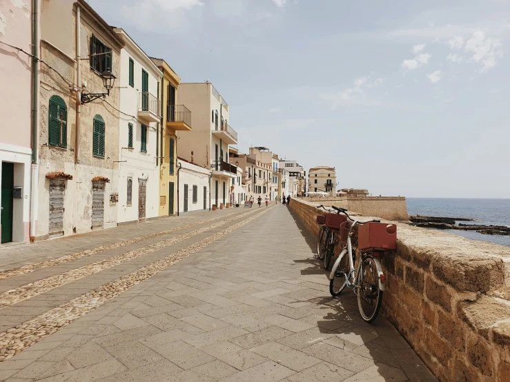 a bicycle parked in front of a building near the sea