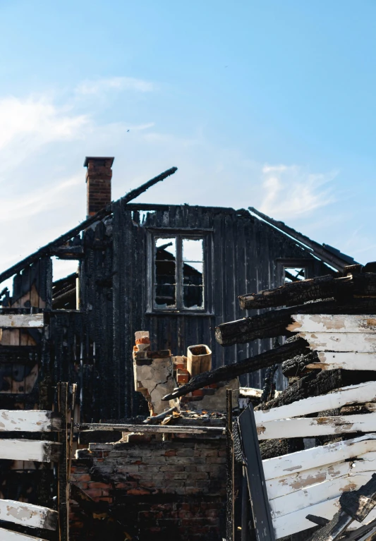 a pile of wood piled up with a house made out of wood