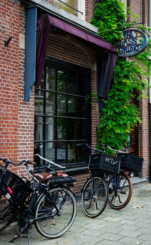 several bikes lined up in front of a brick building