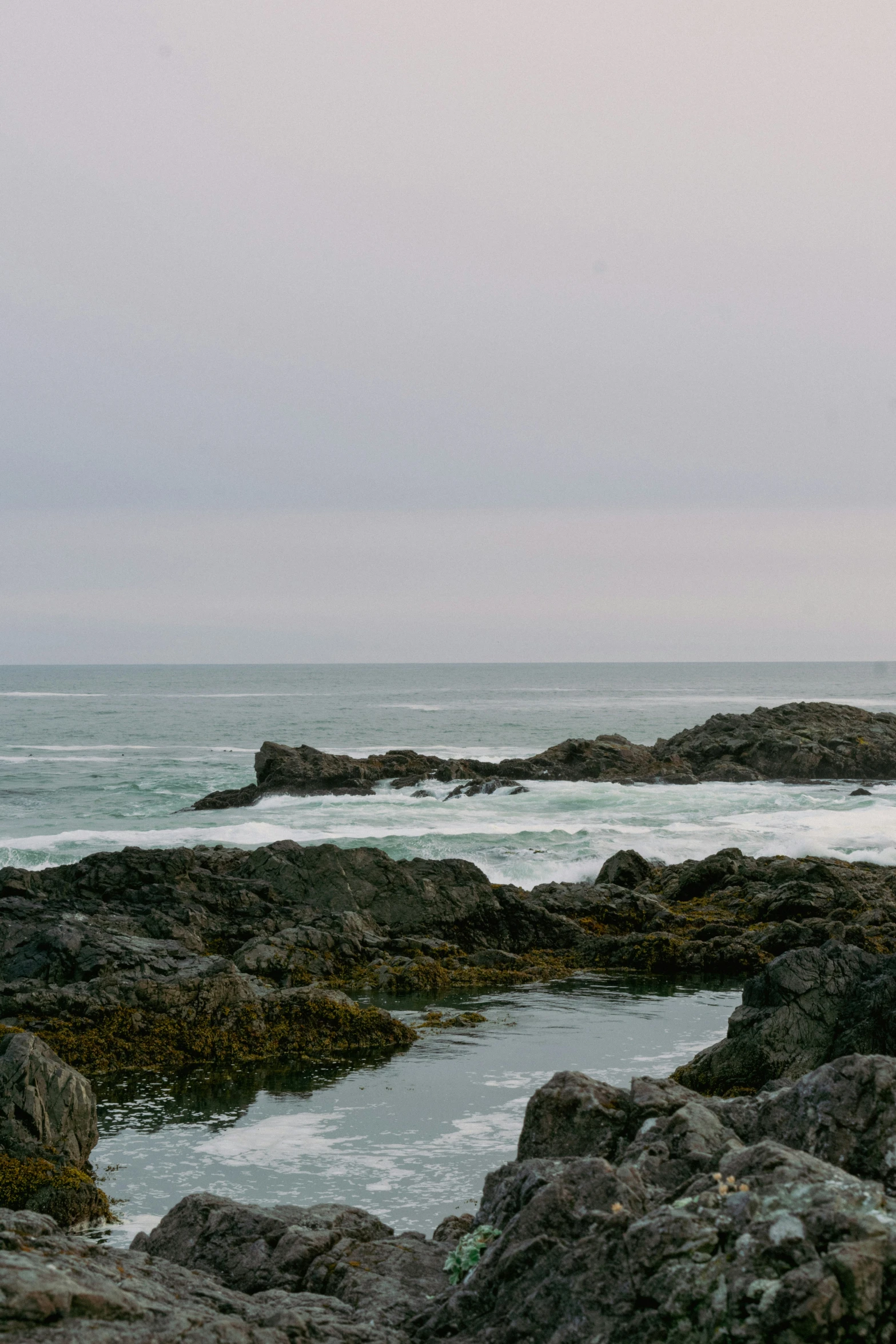 a couple on some rocks under an umbrella