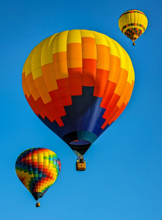 several large balloons are flying in the air