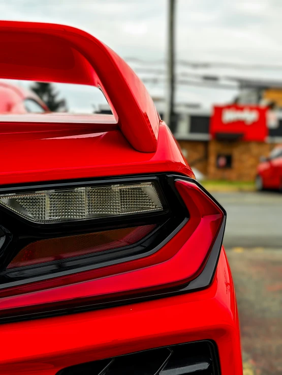 a bright red sports car parked in a lot