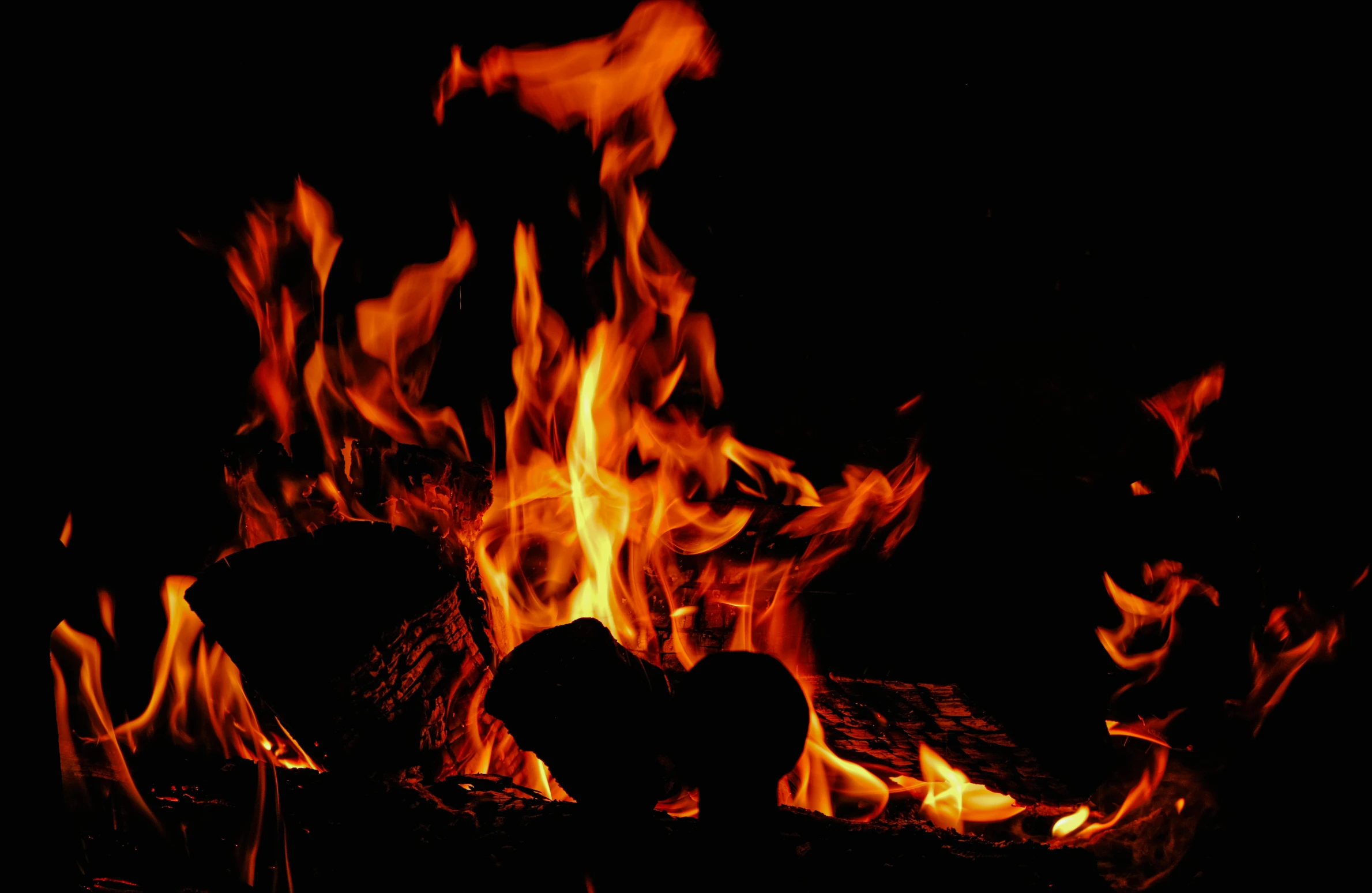 a dark lit fire in the middle of an open space