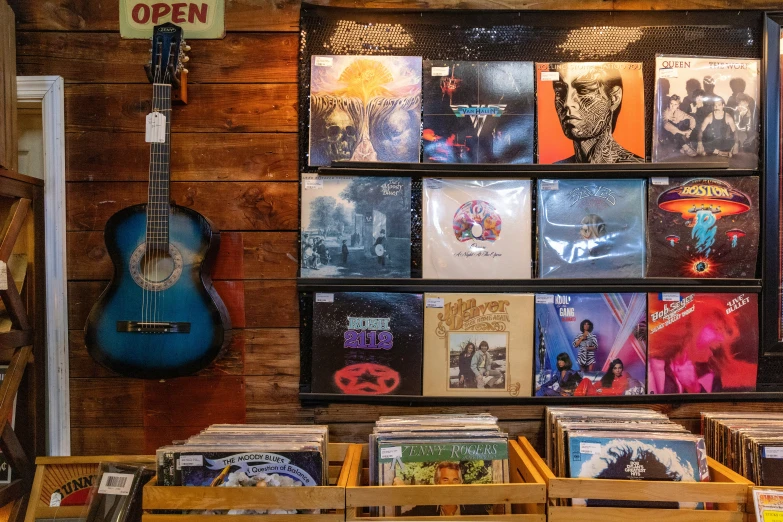 the outside of a music store with various pictures on the wall