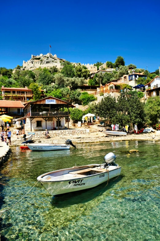 three small boats in a shallow body of water