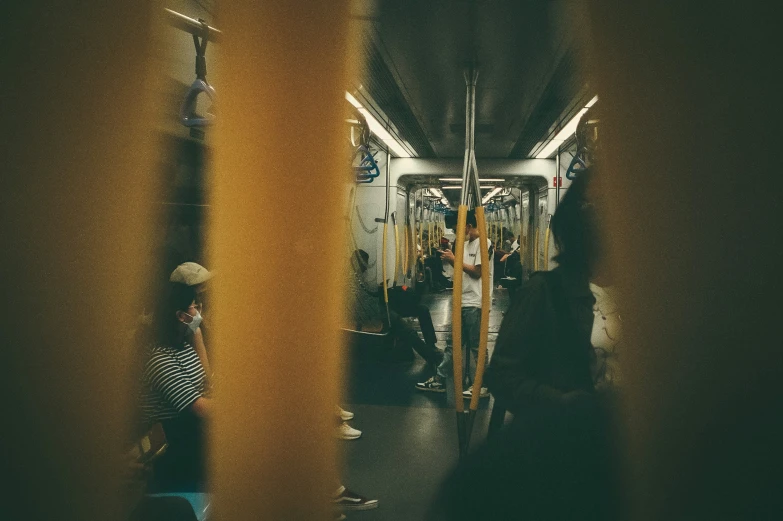 people on a subway train are traveling along side each other