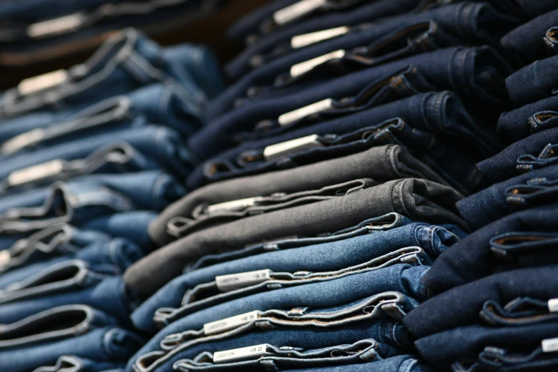 there is a large group of folded jeans