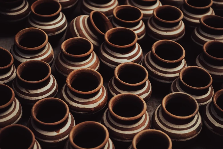 rows of wooden jars are stacked on top of each other