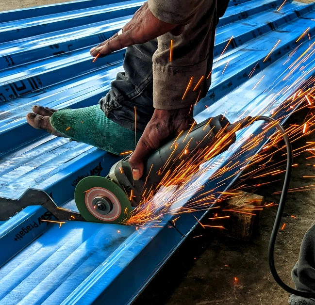 the worker is grinding metal with a grinder