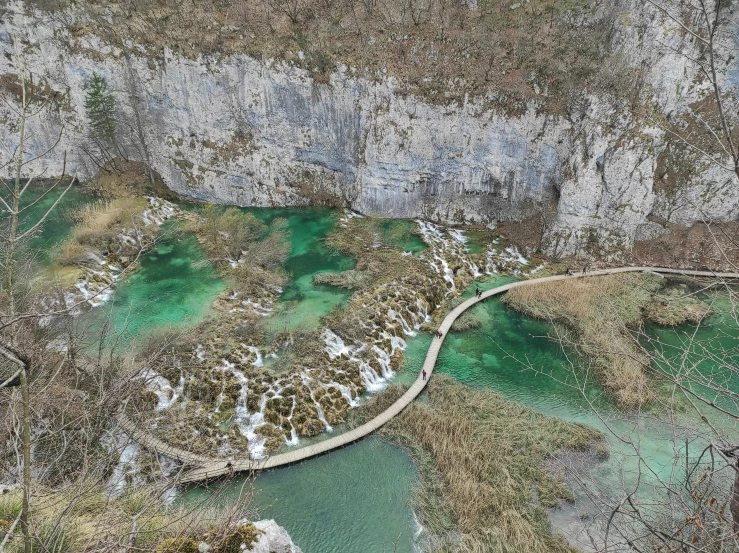 an aerial view of a lake on a hill side