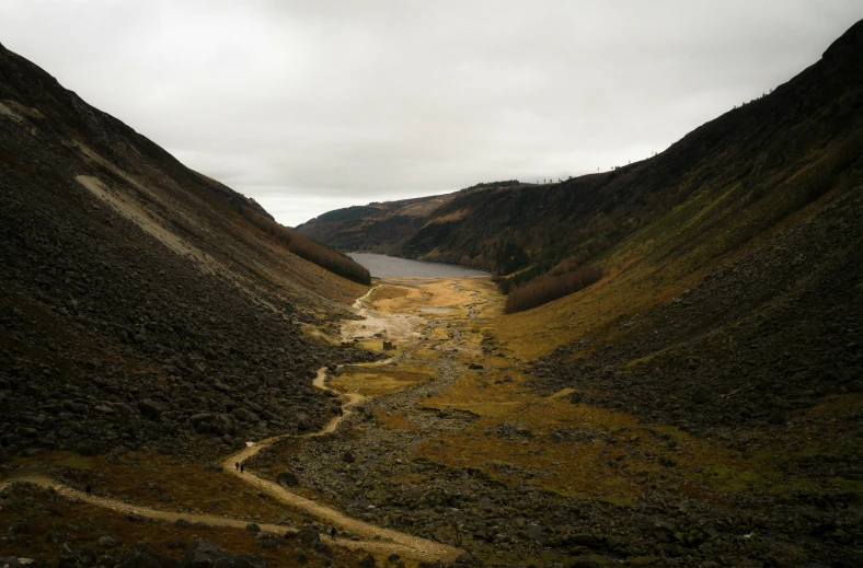 a stream cuts through a mountain valley