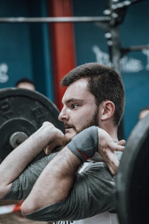 a guy with a beard is doing a squat
