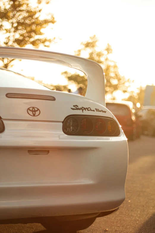 the rear end of a white toyota corollar