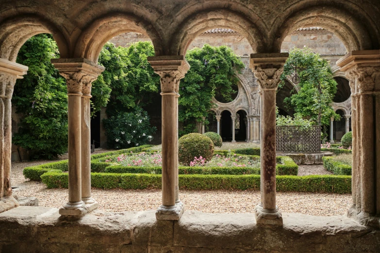 there are arches in the building and an area with landscaping