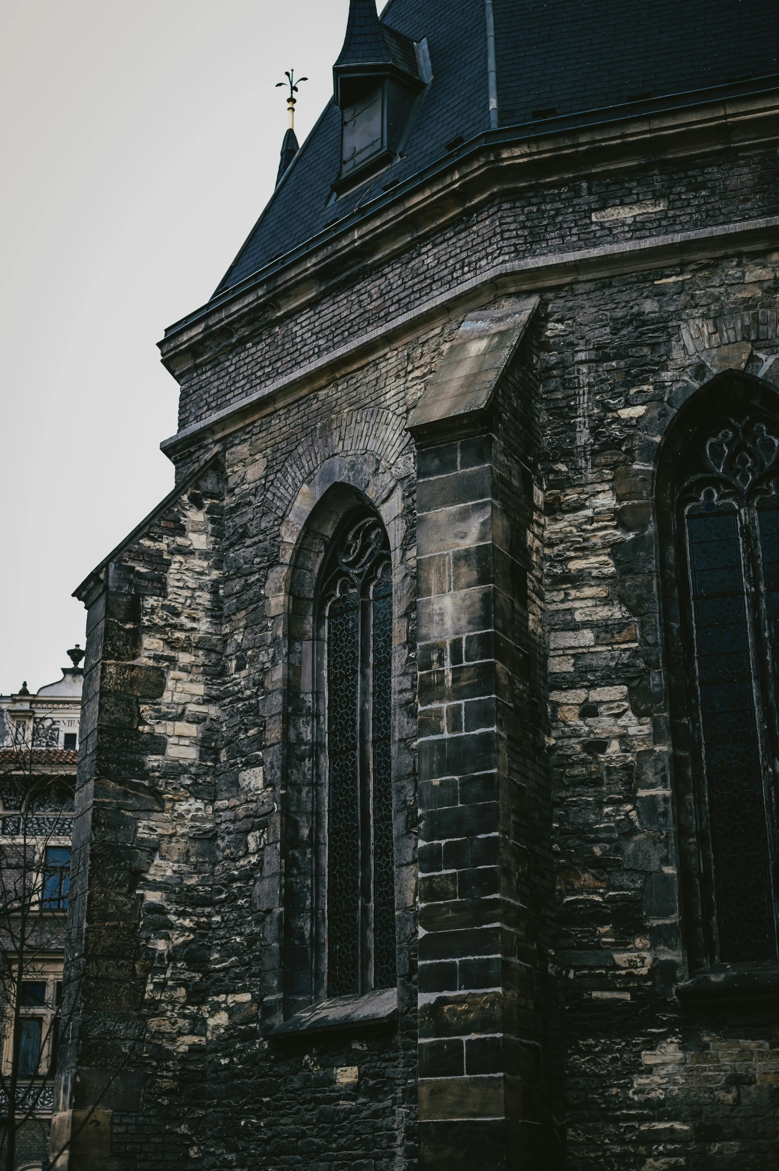 an old church building with two towers and a sky background