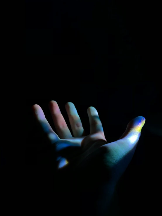 a hand with the bright light coming through the palm