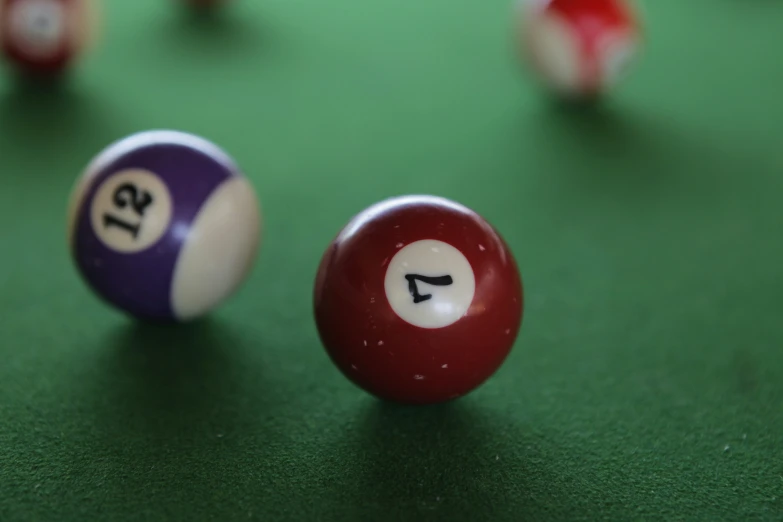 a couple of pool balls that are sitting on the ground
