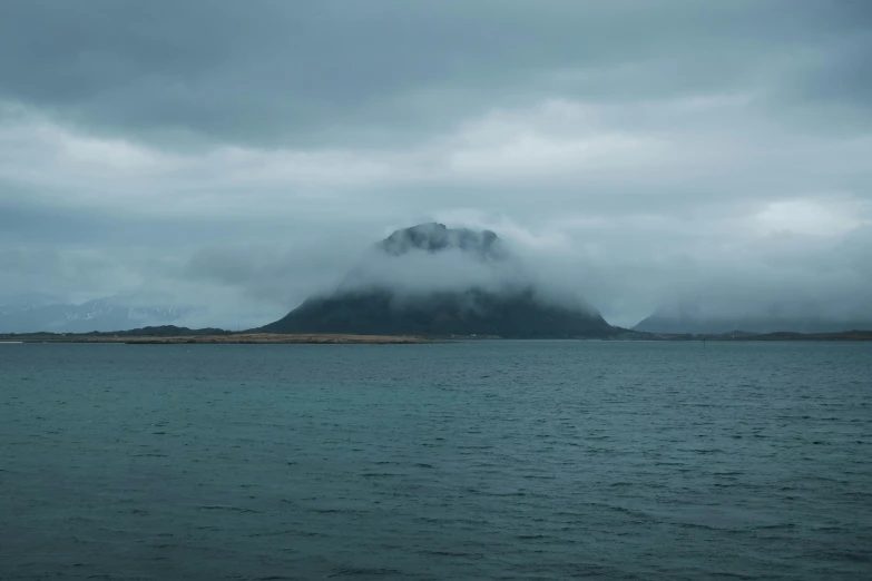 an image of the sea and mountains during storm