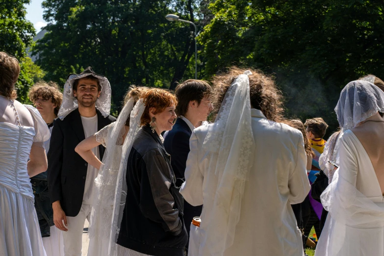 a group of people dressed in white are standing on a street