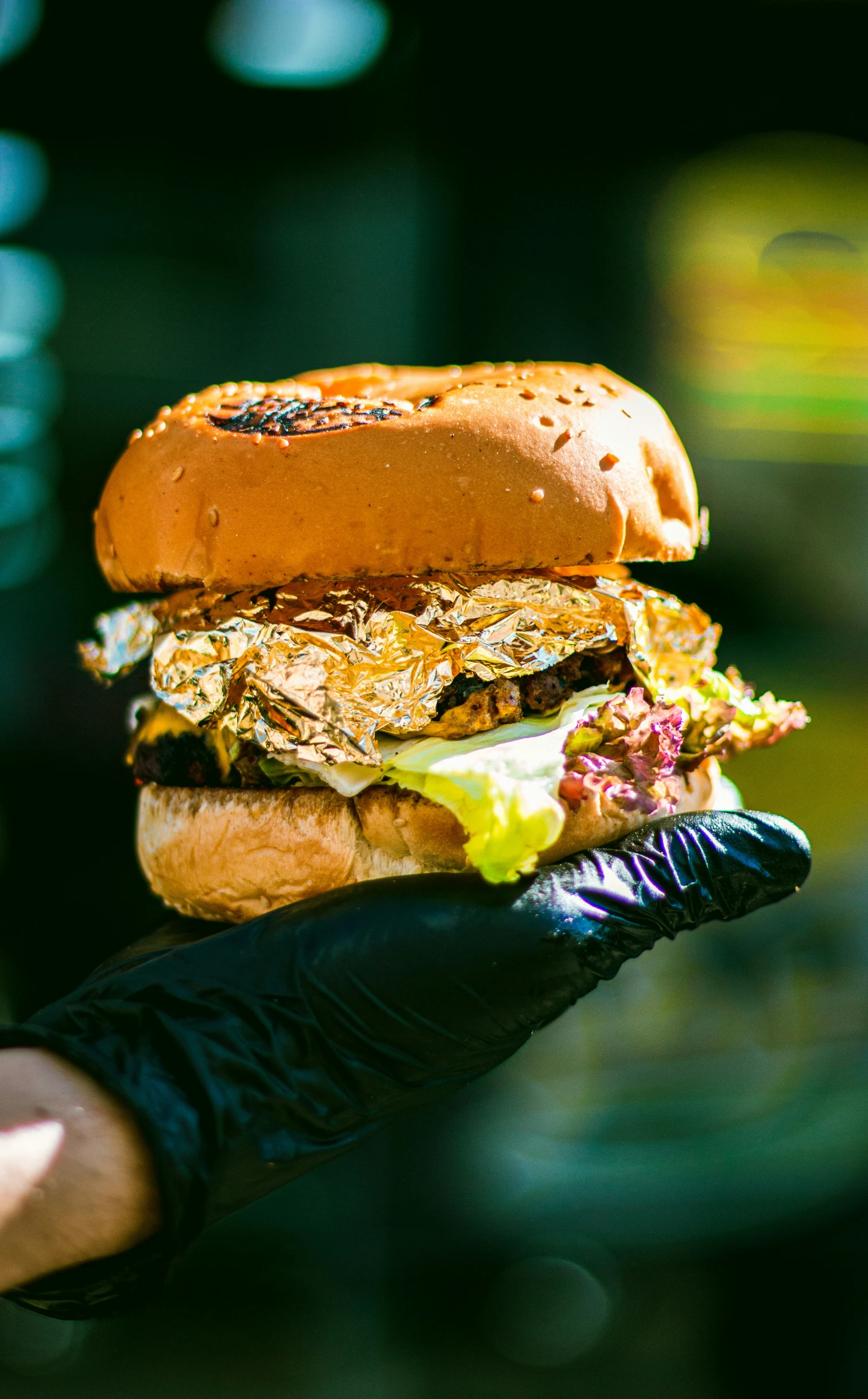 a person holding up a hamburger in their hand