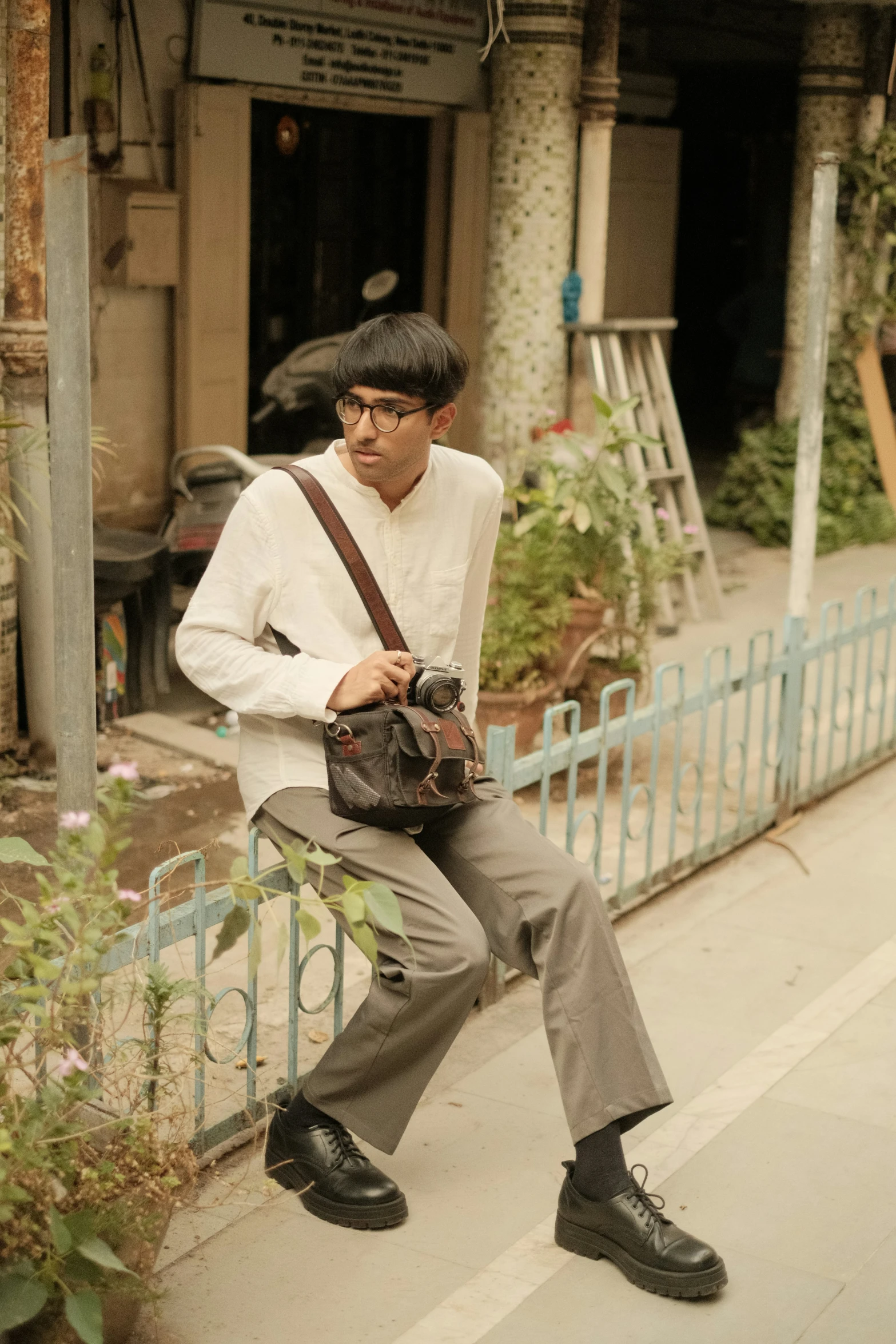 a man with black hair holding up a camera