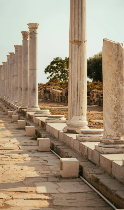 a large bunch of old columns by the street