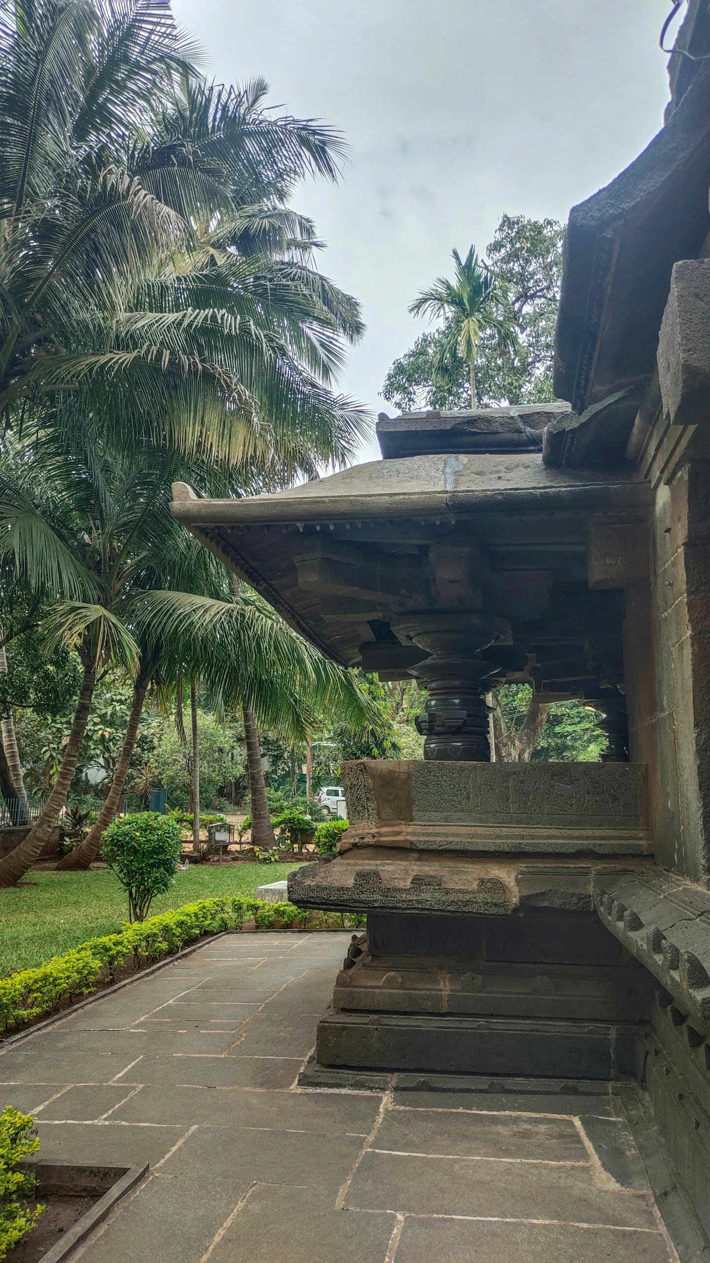 an old stone bench sits in a park near trees