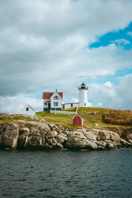 an old light house on the edge of a body of water