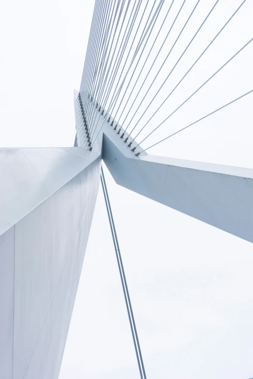 the top portion of a tall bridge with a white top