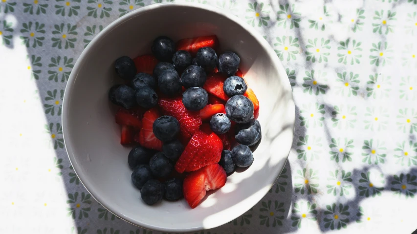 there is strawberries and blueberries in the bowl