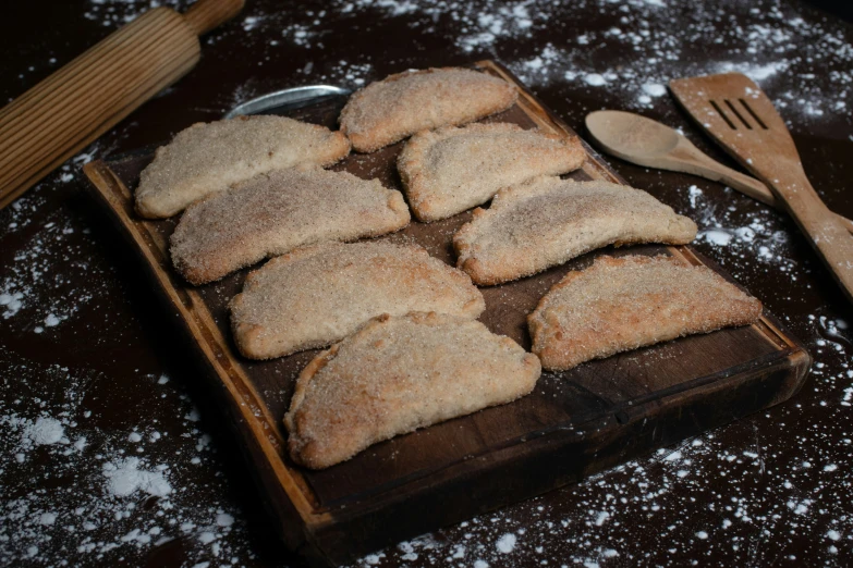 a wooden tray with cookies on top of it