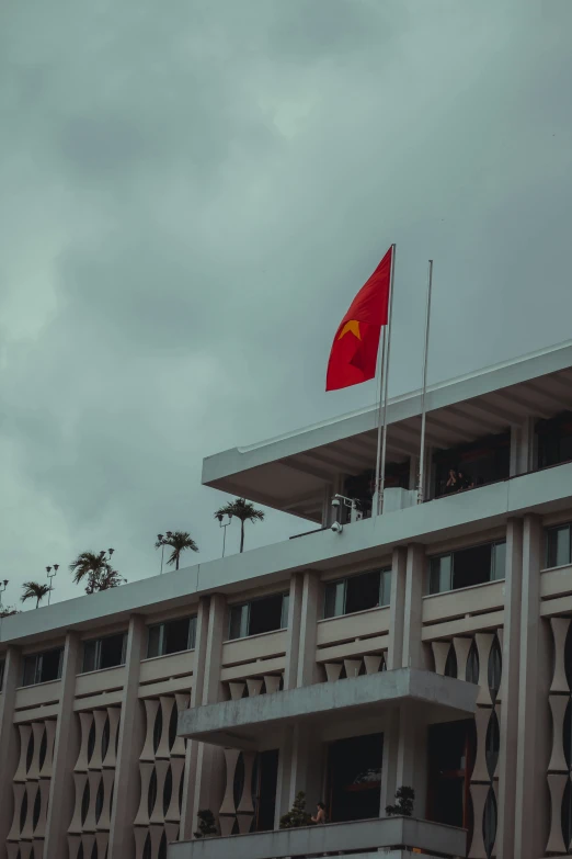 a flag is flying at a building with multiple stories